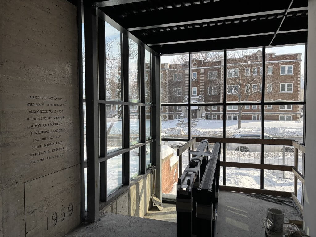 Almost completed construction pic looking out of grid of windows onto street